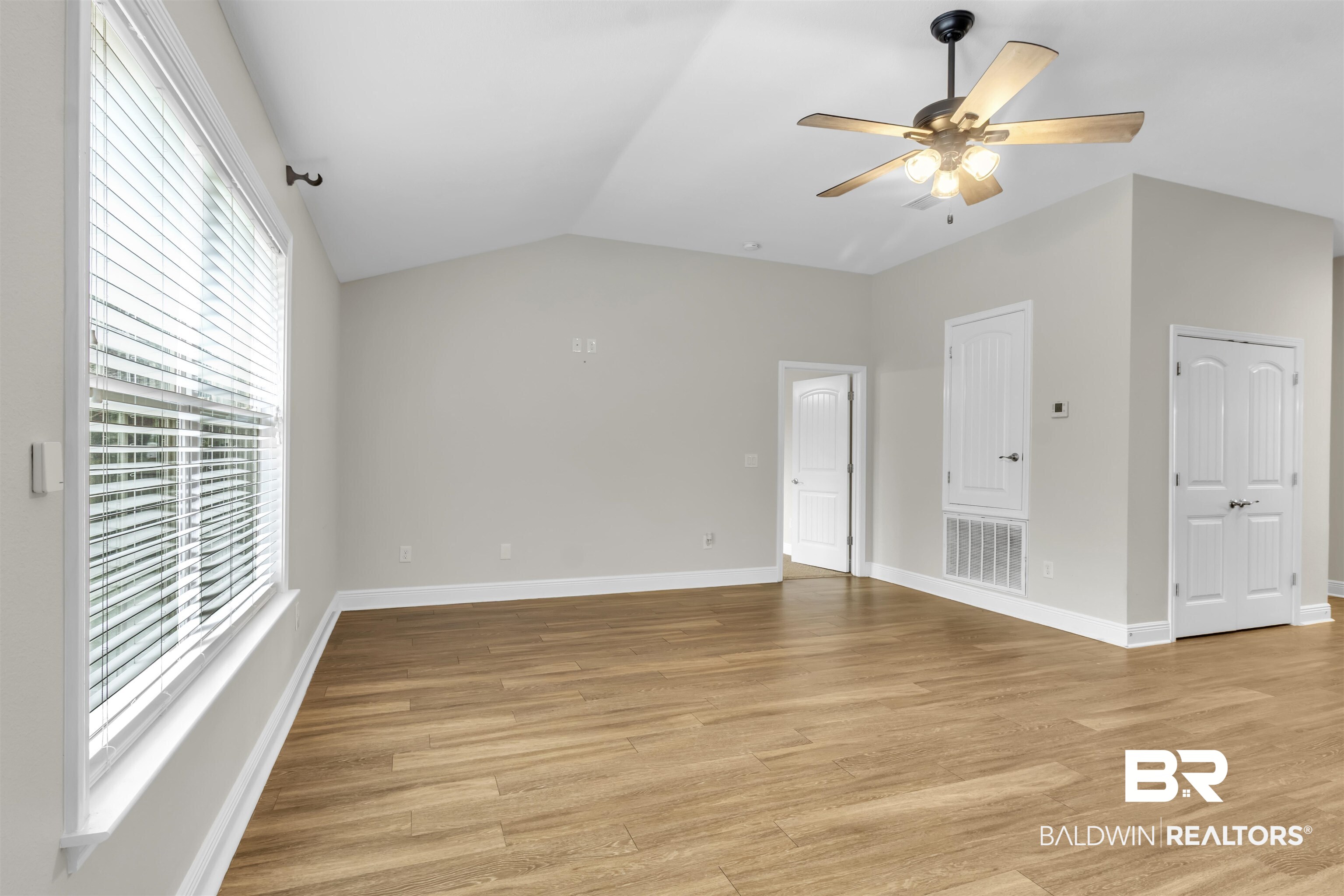 13166 Hulbert Court Foley, AL 36535 - Photo 11 of 27 Unfurnished room featuring light wood finished floors, vaulted ceiling, and ceiling fan