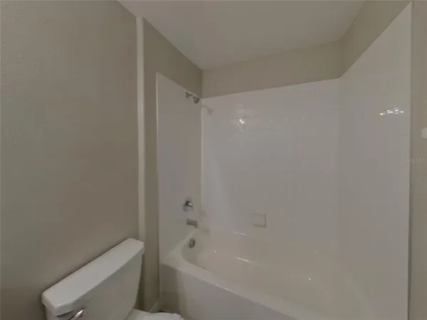 a bathroom with a bathtub and toilet