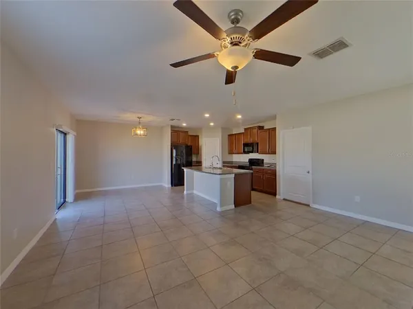 a view of a kitchen with a sink and a ceiling fan
