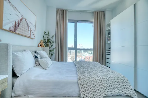 a bedroom with a large bed and a window