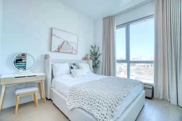 a bedroom with a bed and a desk