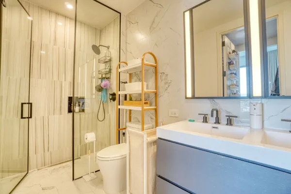 a bathroom with a toilet sink shower and mirror
