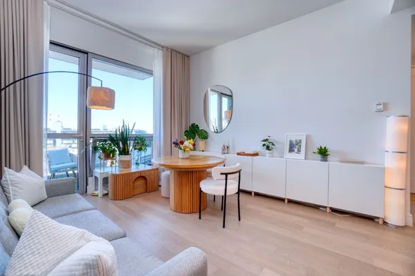 a living room with furniture a table and a potted plant