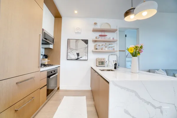 a kitchen with stainless steel appliances granite countertop a sink and a stove