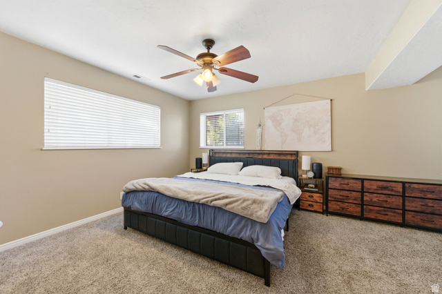 2632 North 140 West Sunset, UT 84015 - Photo 8 of 12 Carpeted bedroom featuring a ceiling fan and baseboards