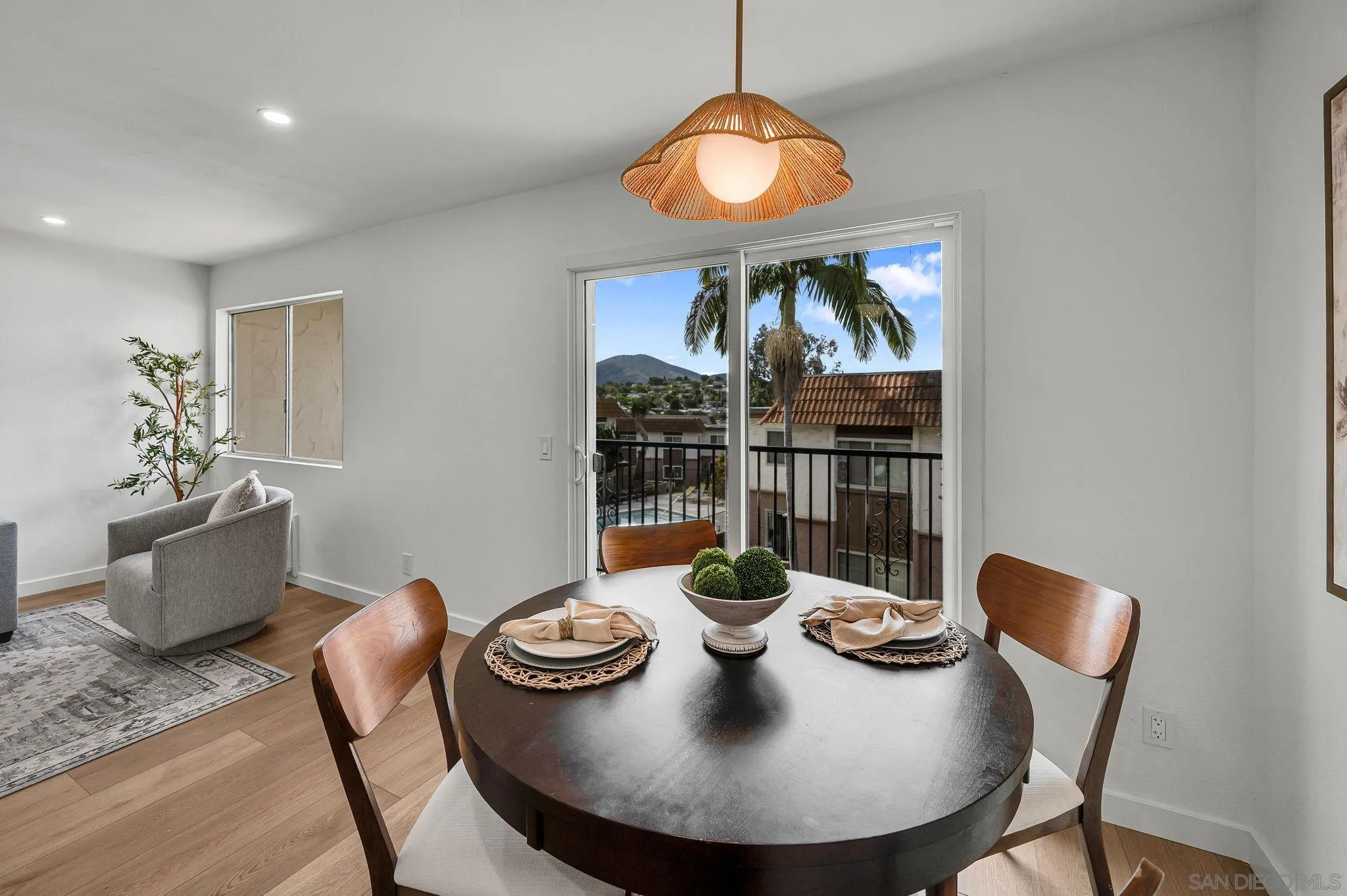 10235 Madrid Way, Unit 108 Spring Valley, CA 91977 - Photo 11 of 22 a view of a dining room with furniture wooden floor and chandelier