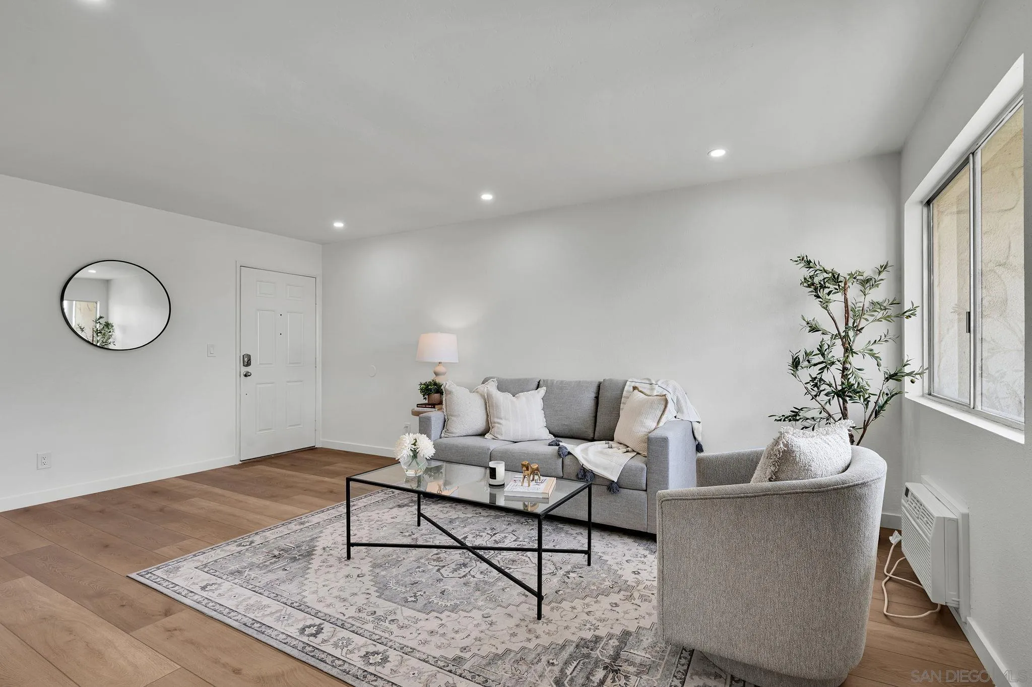 10235 Madrid Way, Unit 108 Spring Valley, CA 91977 - Photo 3 of 22 a living room with furniture and a potted plant