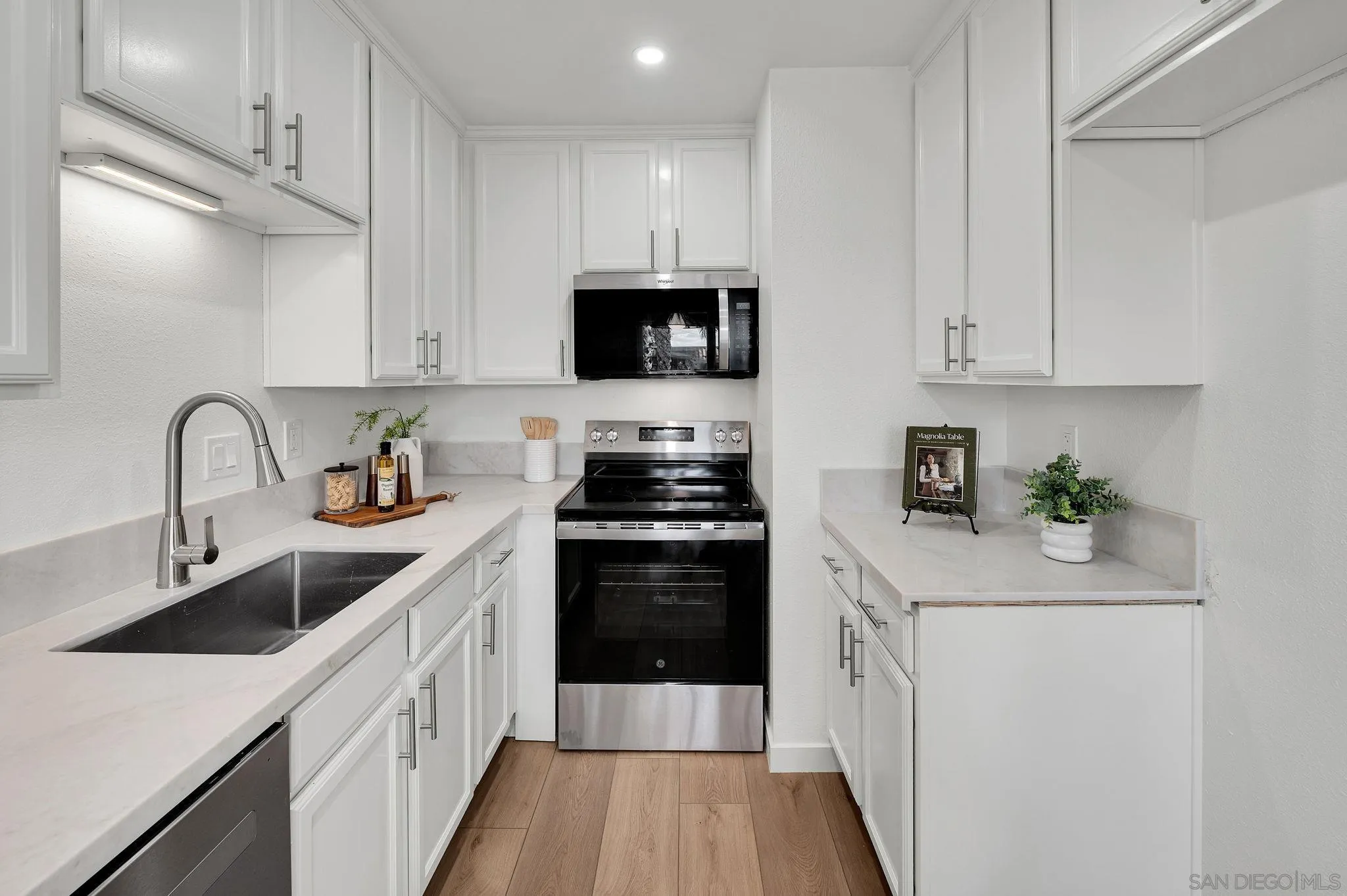 10235 Madrid Way, Unit 108 Spring Valley, CA 91977 - Photo 9 of 22 a kitchen with stainless steel appliances granite countertop a sink stove and refrigerator