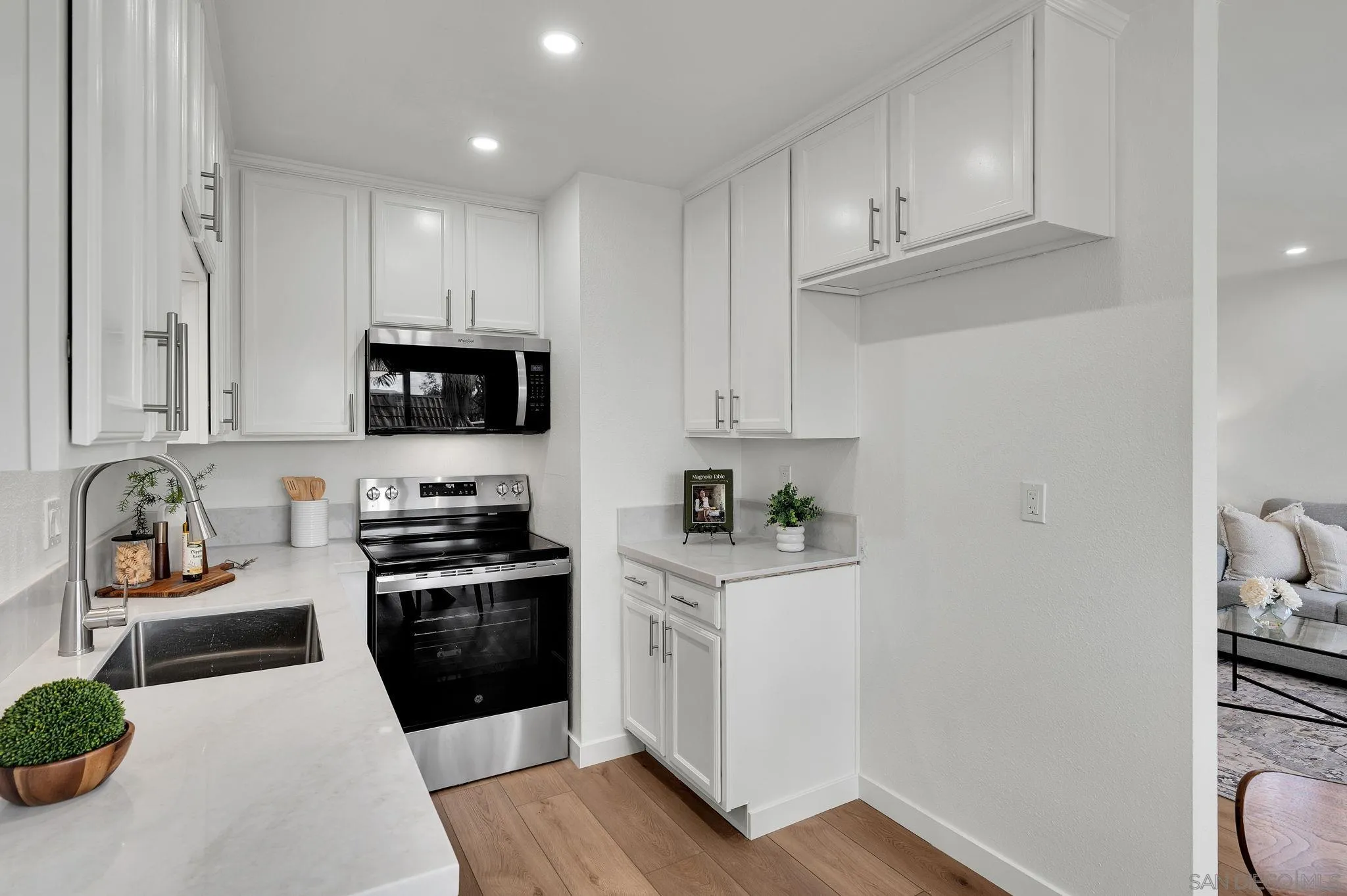10235 Madrid Way, Unit 108 Spring Valley, CA 91977 - Photo 10 of 22 a kitchen with stainless steel appliances a stove a sink a refrigerator and cabinets