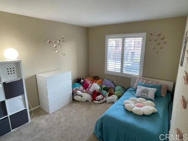 a bedroom with two beds and a window