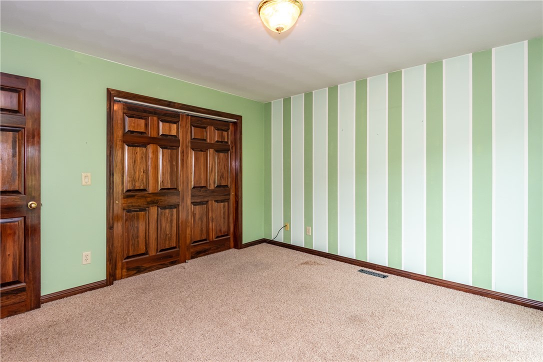 9981 Ridge Acres Lane Englewood, OH 45322 - Photo 22 of 73 This spacious room features ample storage and plush carpet flooring.
