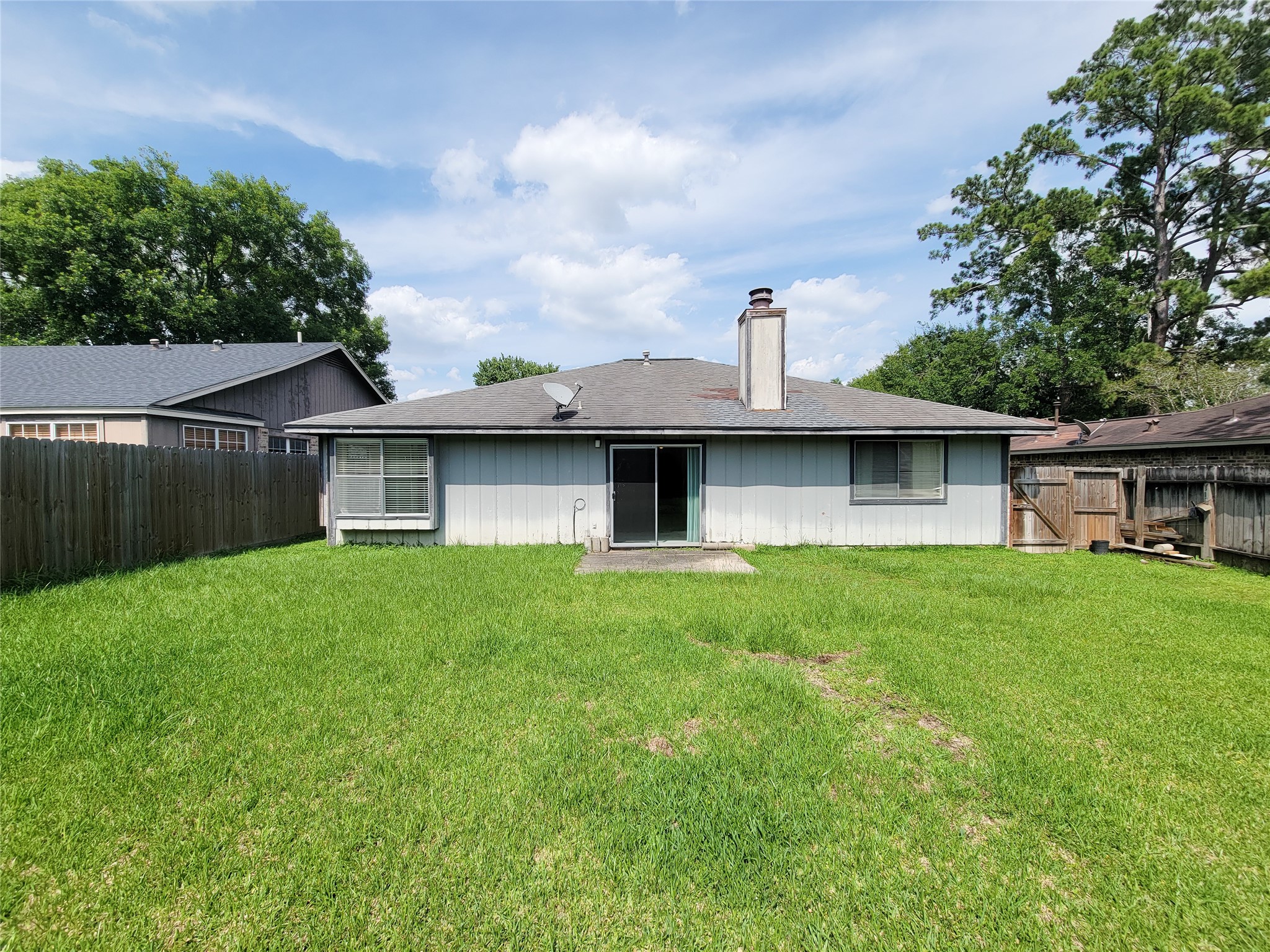 23211 Timberbrook Drive Spring, TX 77373 - Photo 34 of 34 a view of a backyard with table and chairs and wooden fence