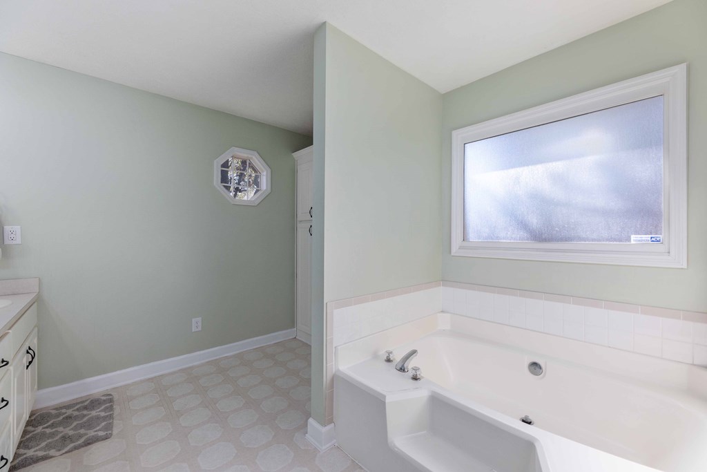 54 Waterford Drive Cataula, GA 31804 - Photo 15 of 25 a bathroom with a bathtub and a window