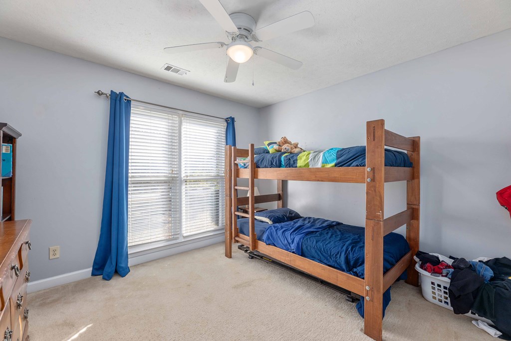 54 Waterford Drive Cataula, GA 31804 - Photo 18 of 25 a bedroom with furniture and a chandelier