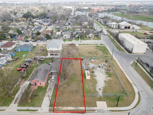 an aerial view of a house with a yard wooden table and chairs