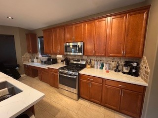 3110 Katner Lane Spring, TX 77386 - Photo 9 of 24 a kitchen with stainless steel appliances granite countertop wooden cabinets a stove top oven a sink and dishwasher