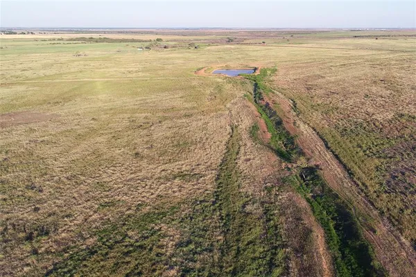 a swimming pool with an outdoor space and seating area