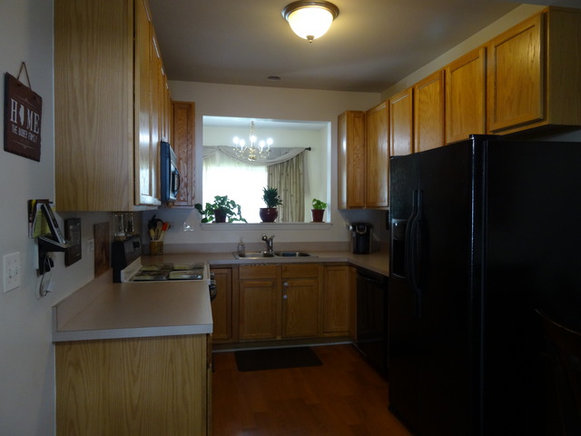 2318 Reflections Drive Aurora, IL 60502 - Photo 7 of 13 a kitchen with a sink a refrigerator and cabinets