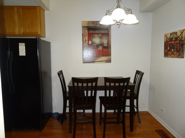 2318 Reflections Drive Aurora, IL 60502 - Photo 8 of 13 a view of a dining room with furniture and wooden floor
