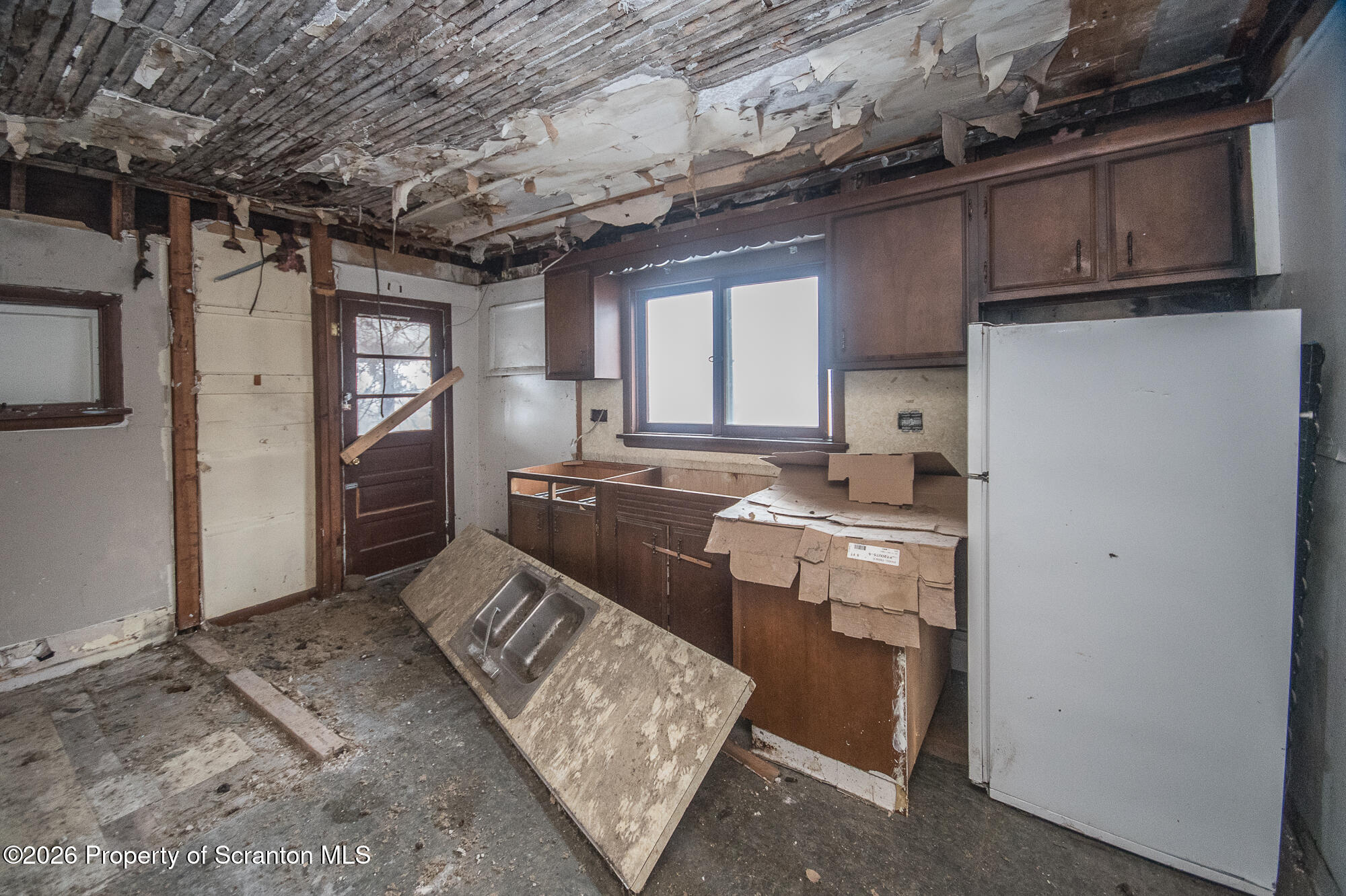 922 West Elm Street Scranton, PA 18504 - Photo 24 of 29 a kitchen with refrigerator and cabinets
