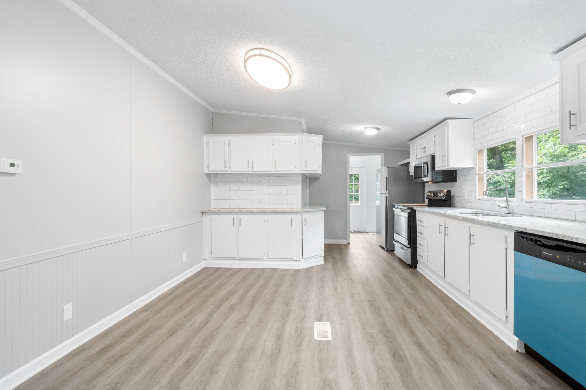 2177 Highway 76 Adams, TN 37010 - Photo 13 of 23 a kitchen with wooden floors and appliances