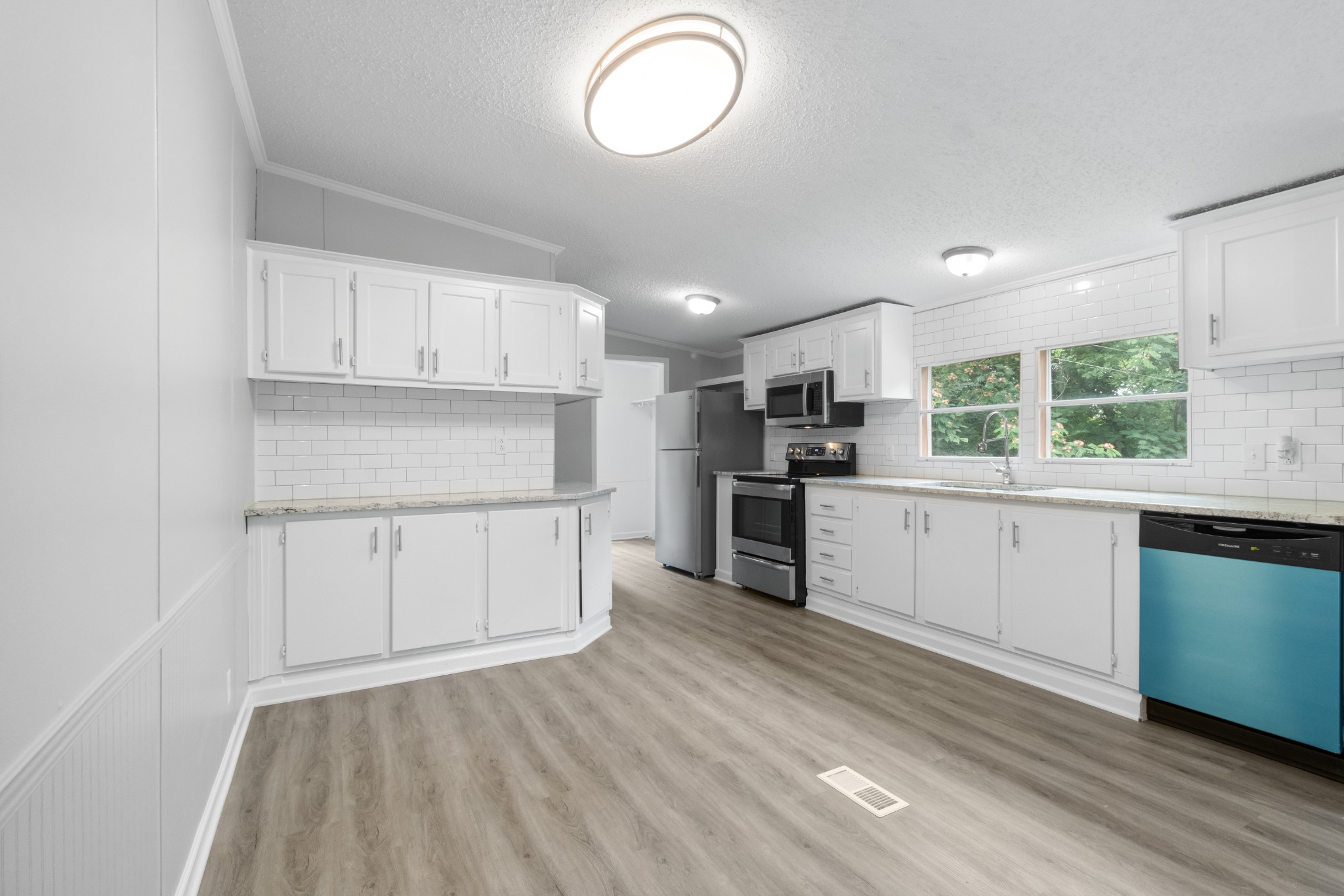 2177 Highway 76 Adams, TN 37010 - Photo 14 of 23 a kitchen with cabinets wooden floor and stainless steel appliances