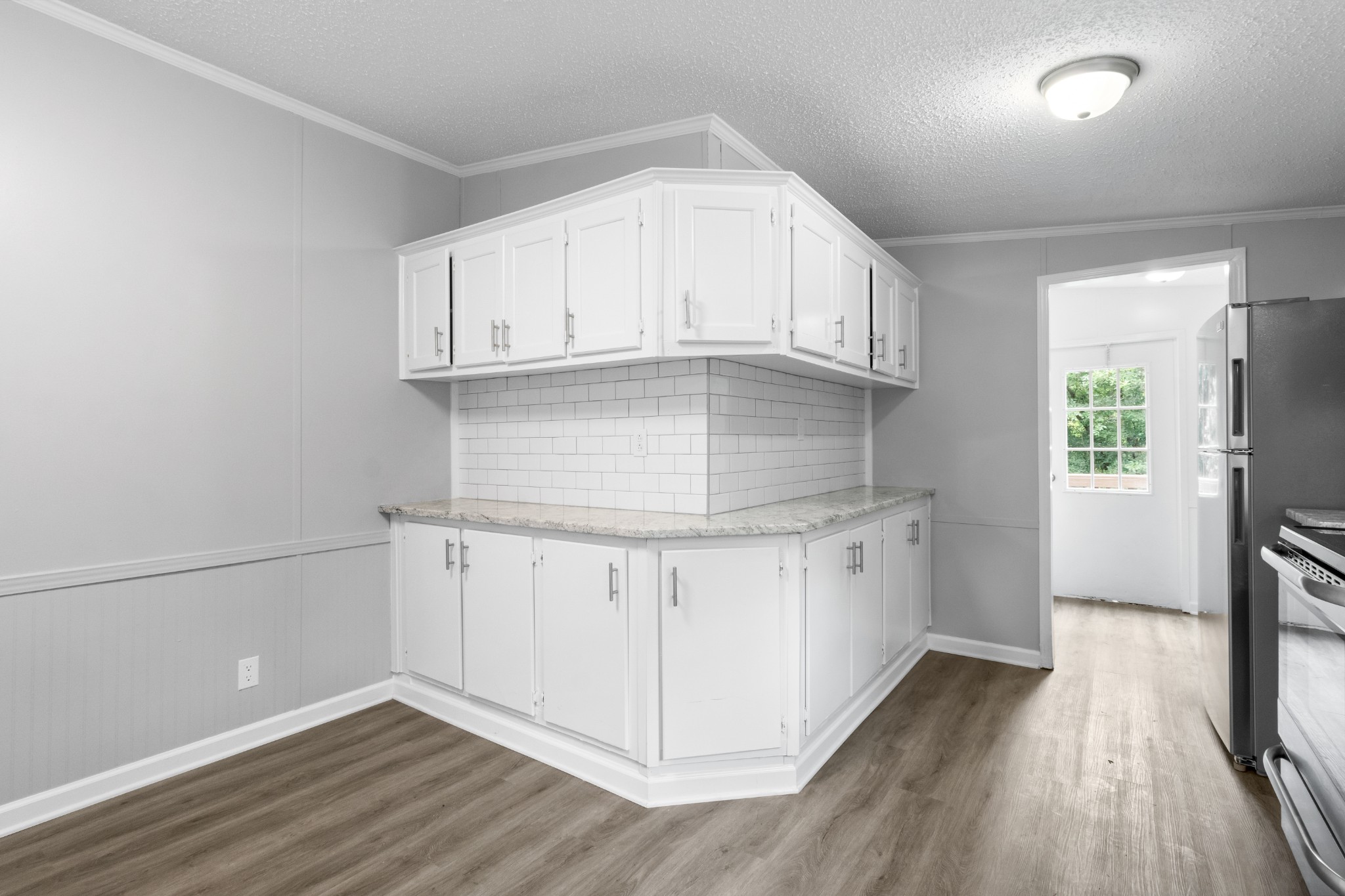2177 Highway 76 Adams, TN 37010 - Photo 16 of 23 a kitchen with granite countertop white cabinets and white appliances