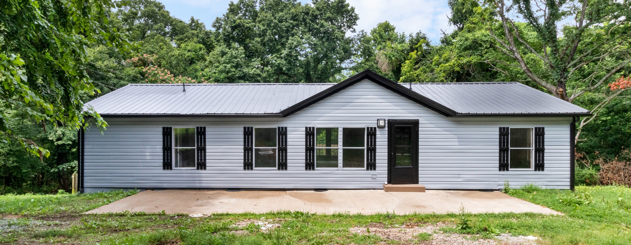 2177 Highway 76 Adams, TN 37010 - Photo 2 of 23 a view of a house with a yard plants and large tree