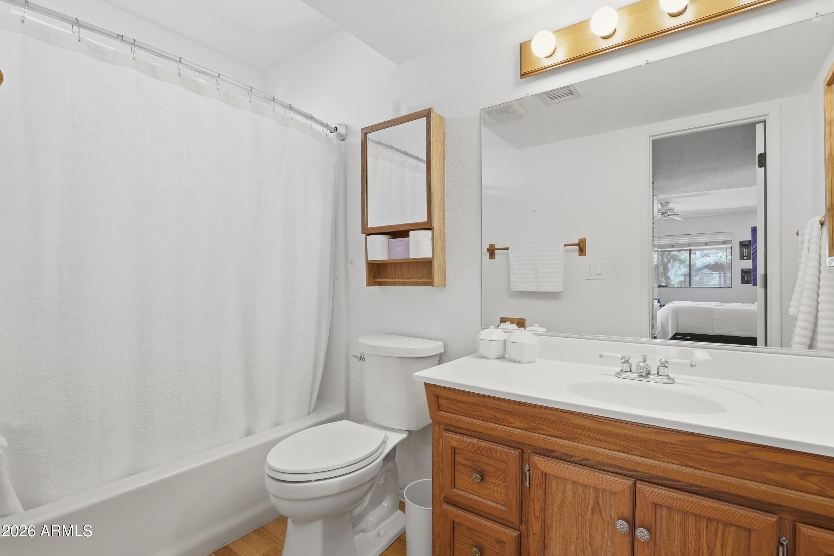201 North McLane Road Payson, AZ 85541 - Photo 12 of 42 a bathroom with a granite countertop toilet sink and mirror