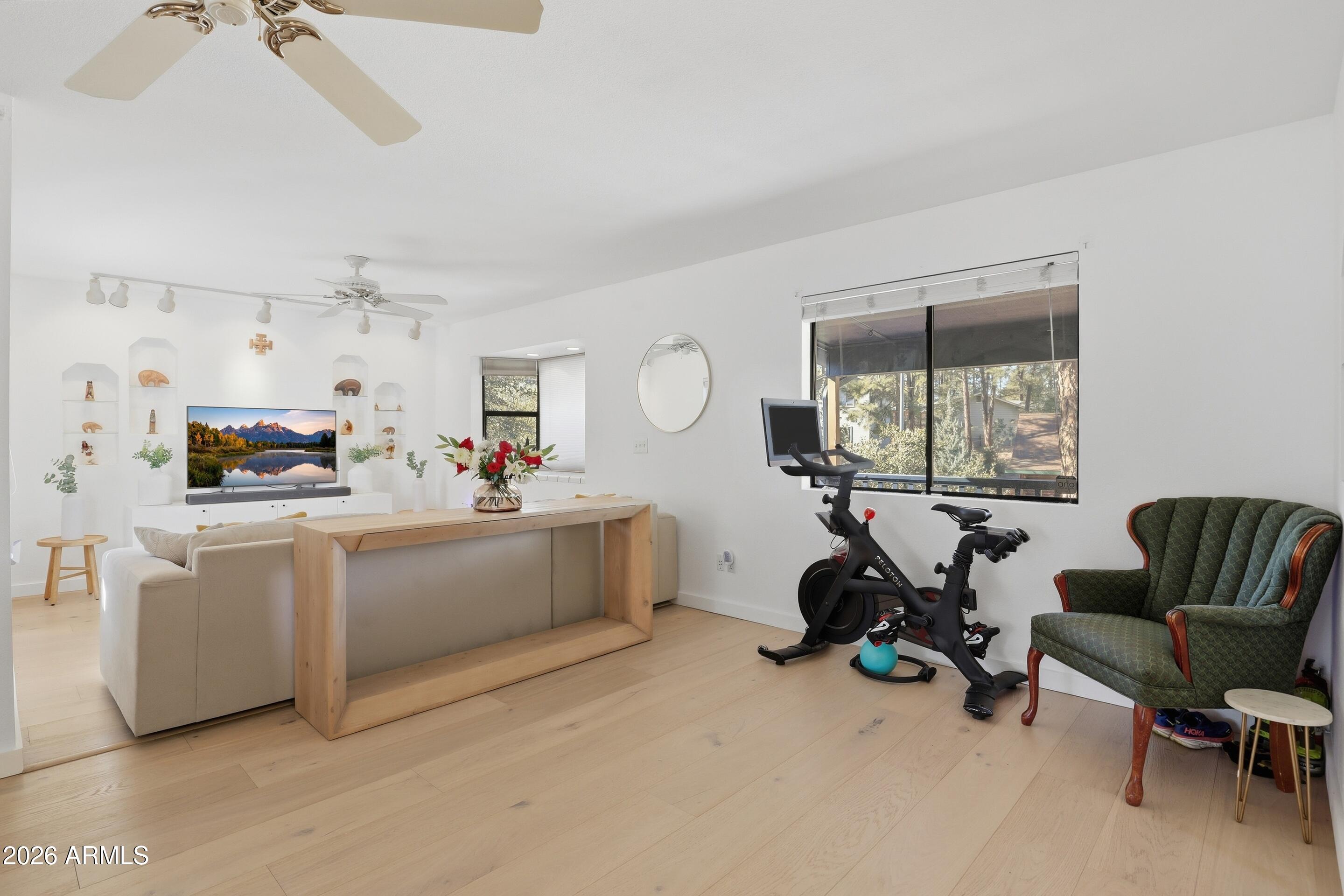 201 North McLane Road Payson, AZ 85541 - Photo 8 of 42 a living room with furniture a window and gym equipment