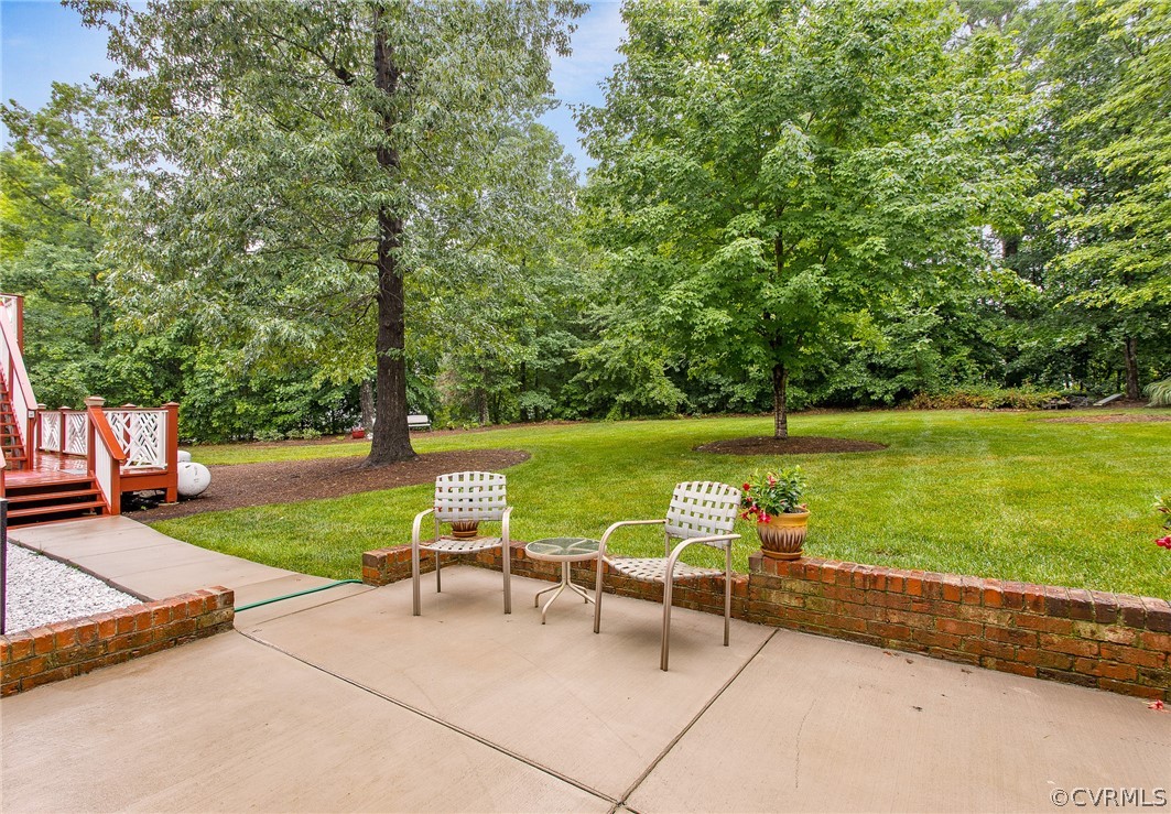 610 Courthouse Road North Chesterfield, VA 23236 - Photo 44 of 50 a view of a lake with couches and table under an umbrella