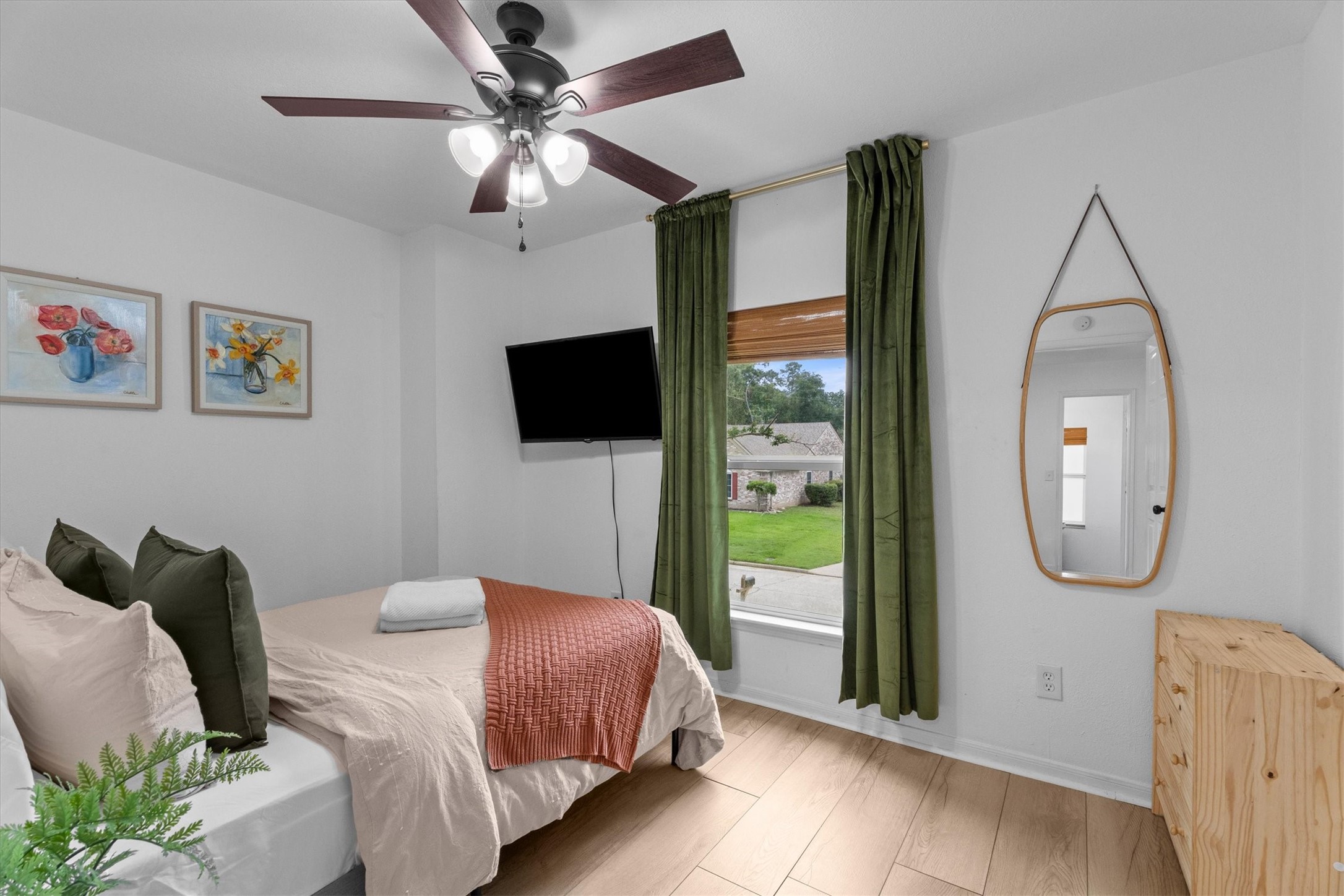 503 Alley Court Spring, TX 77388 - Photo 6 of 48 a spacious bedroom with a bed a mirror on dresser and a flat screen tv