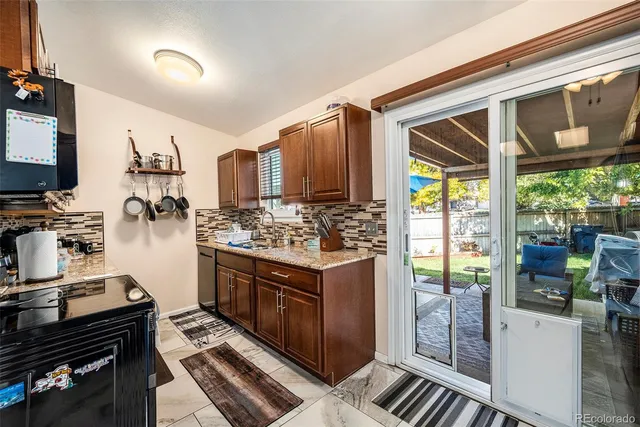 a kitchen with a stove a refrigerator and wooden cabinets