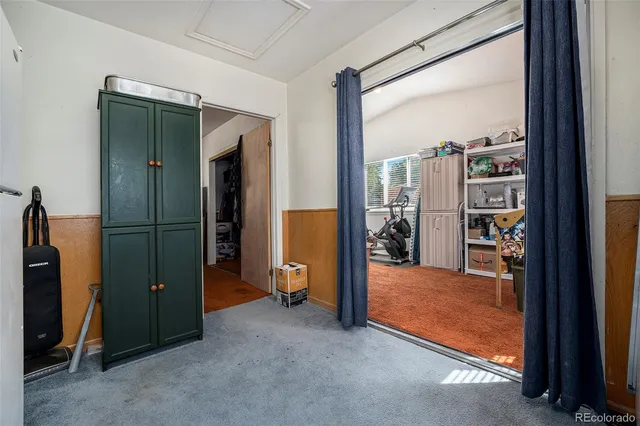 an empty room with closet and a bathroom