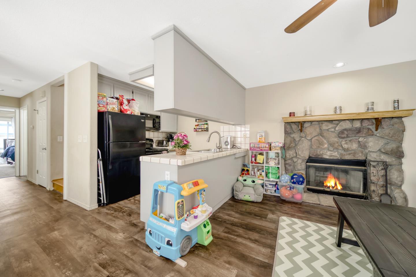 440 Golf Circle Manteca, CA 95337 - Photo 12 of 31 a kitchen with a refrigerator and a fireplace