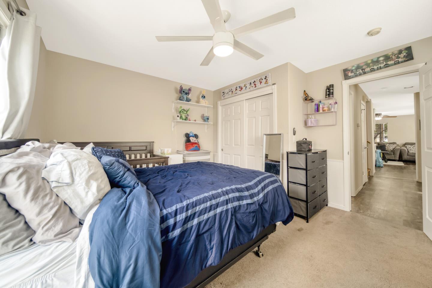 440 Golf Circle Manteca, CA 95337 - Photo 19 of 31 a bedroom with two beds and a chandelier