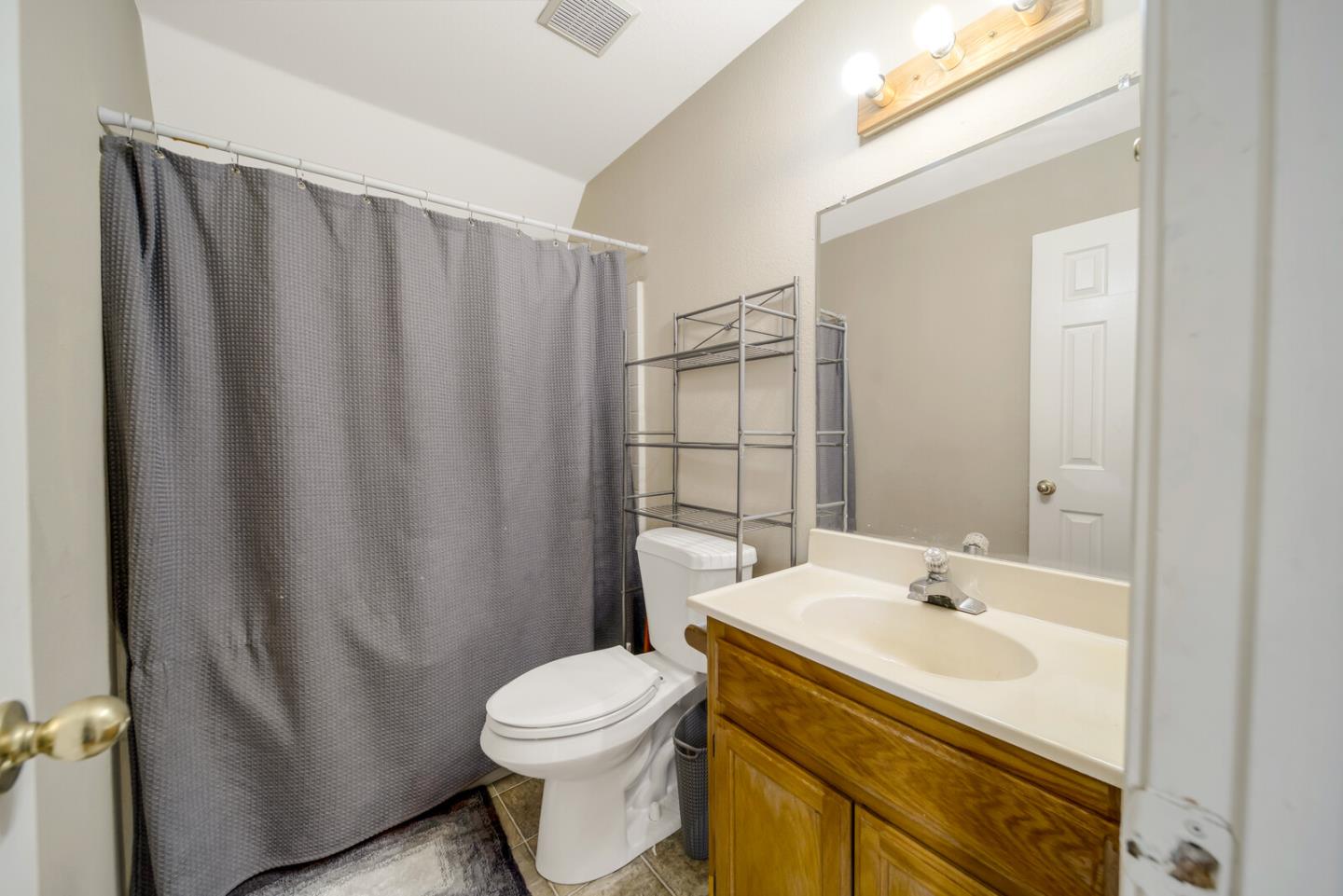 440 Golf Circle Manteca, CA 95337 - Photo 24 of 31 a bathroom with a sink a toilet and shower