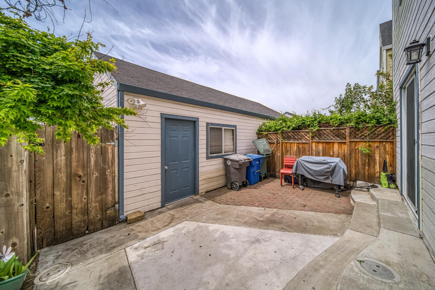440 Golf Circle Manteca, CA 95337 - Photo 8 of 31 a view of a patio with table and chairs potted plants with wooden fence