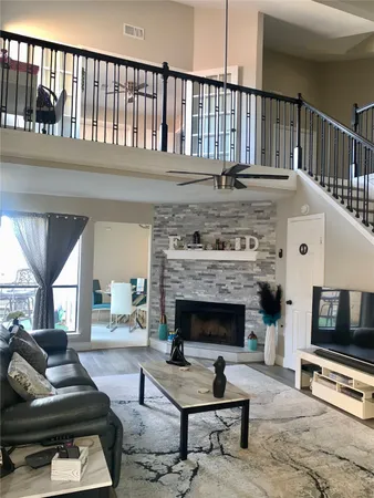 a living room with furniture fireplace and flat screen tv