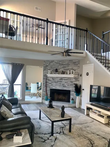 a living room with furniture fireplace and flat screen tv