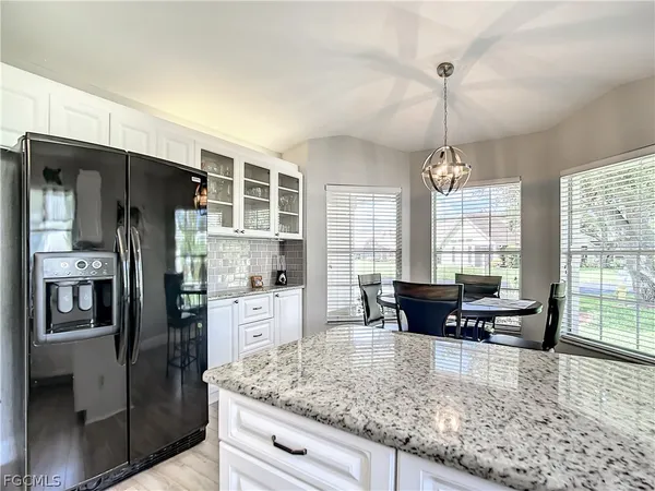 a kitchen with granite countertop a stove and a microwave