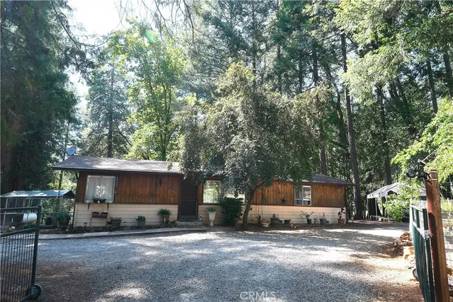 a view of house with car parked beside of road