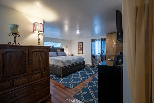 a bedroom with furniture and wooden floor