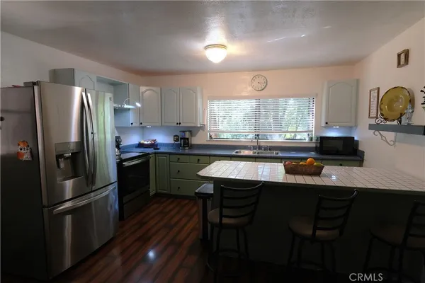 a kitchen with a sink stainless steel appliances and window