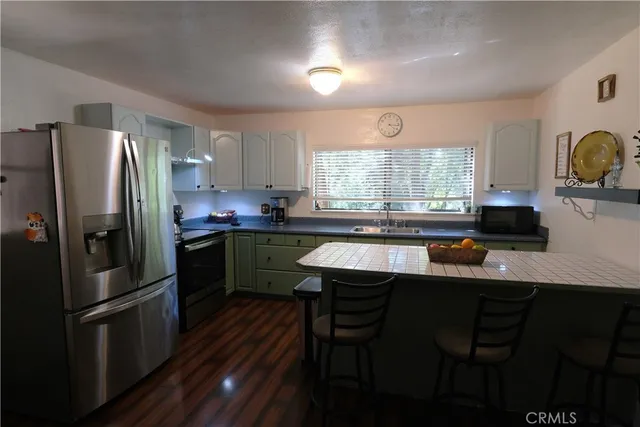 a kitchen with a sink stainless steel appliances and window