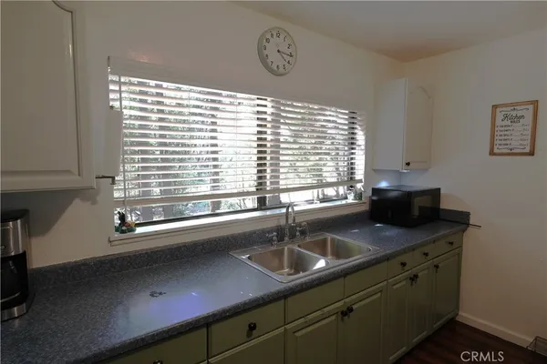a kitchen with stainless steel appliances a sink a counter and a window