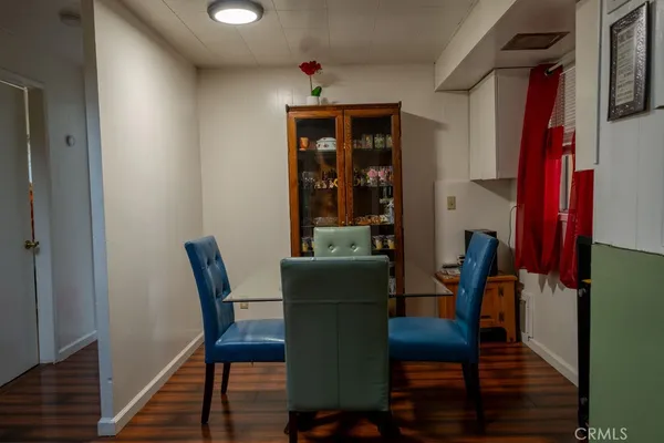 a dining room with furniture and wooden floor