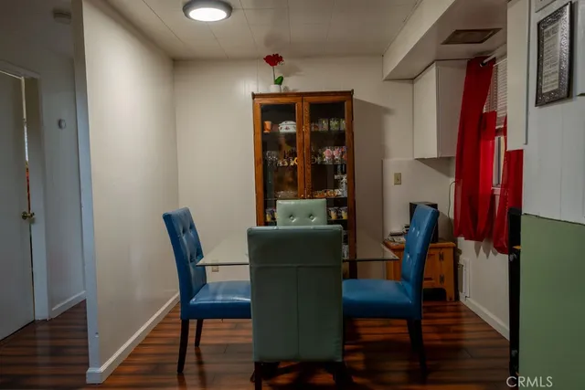 a dining room with furniture and wooden floor