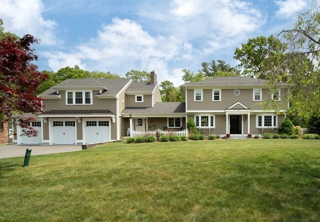 a front view of a house with a garden