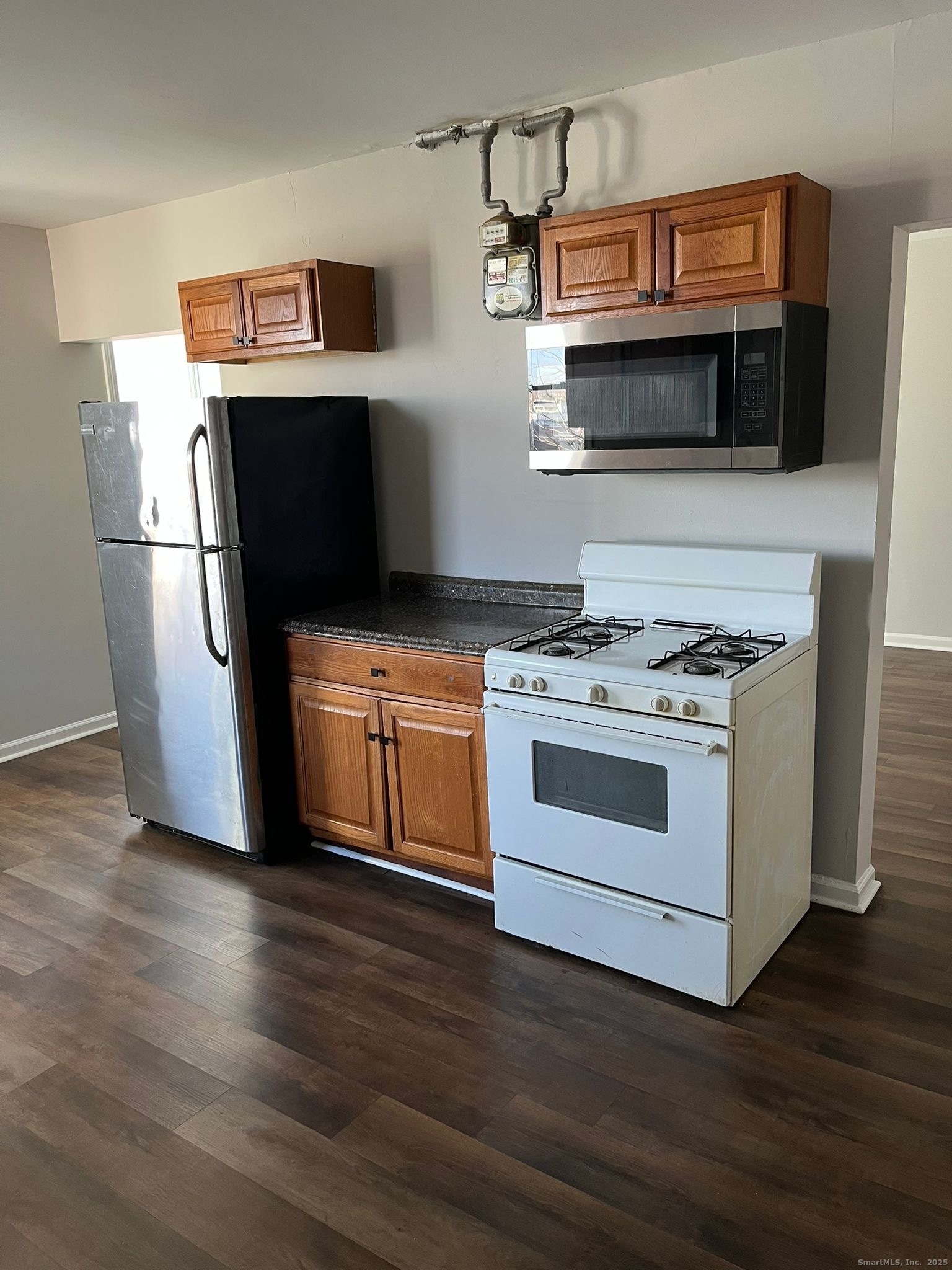 a kitchen with cabinets and steel stainless steel appliances